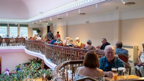 An image of people sat on the balcony in the Winter Garden