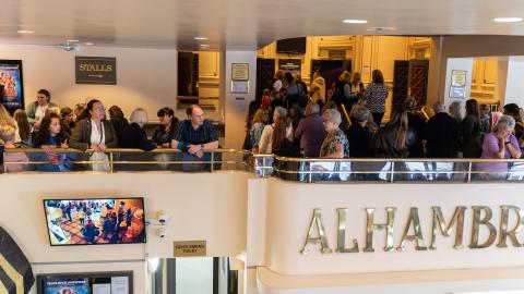 People gathering in the foyer of the Alhambra before a show.