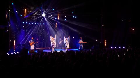 A group of musicians on stage for an ABBA tribute concert.