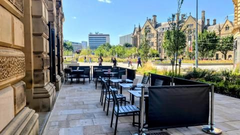 Tables and chairs neatly arranged outside St George's Hall