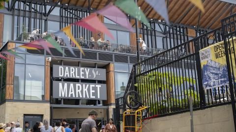 A landscape image of Darley Street Market with colourful bunting hanging outside.