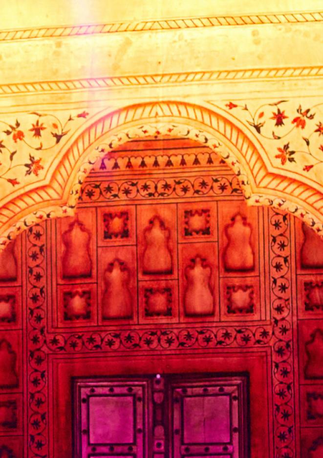 A graphic of some intricate architecture lit with yellow and orange.