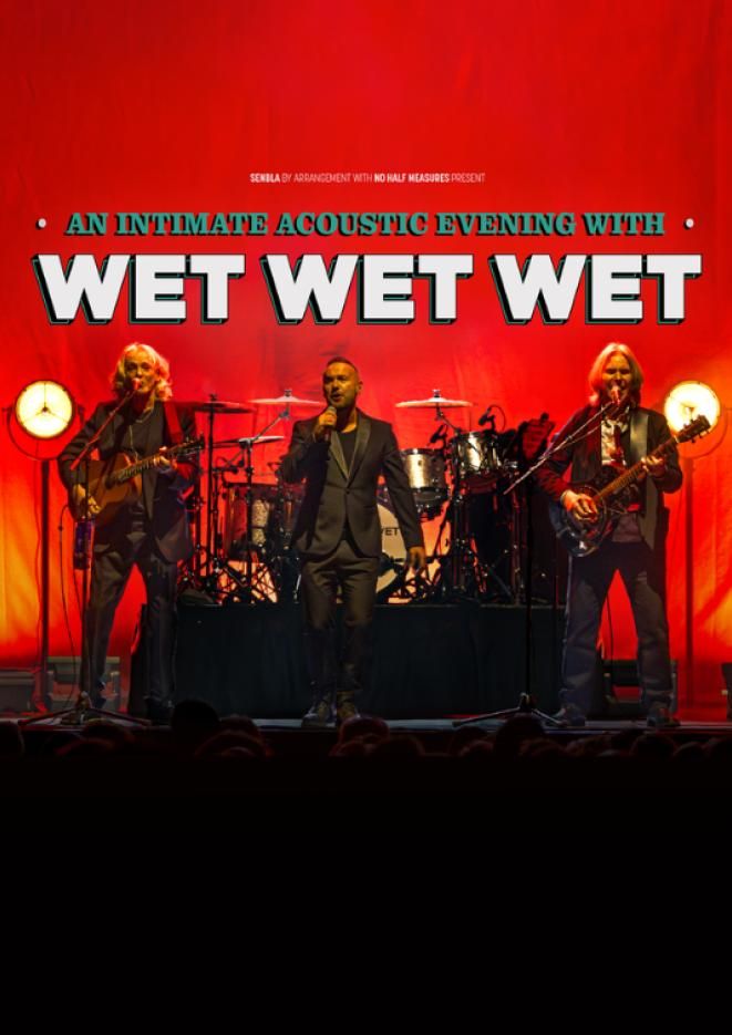 Members of the musical group Wet Wet Wet performing on stage against a bright red background.