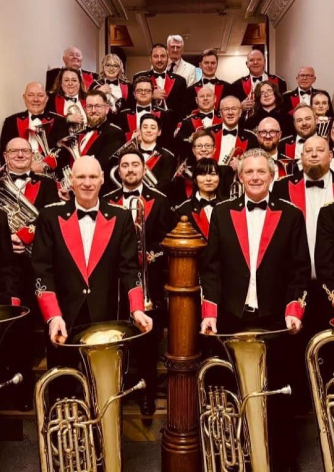 Members of a brass band stood with their instruments.