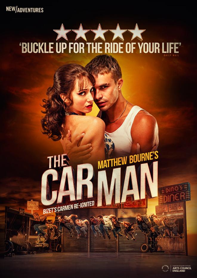 A woman and a man hold each other and look at the camera, against a backdrop of people dancing by a garage