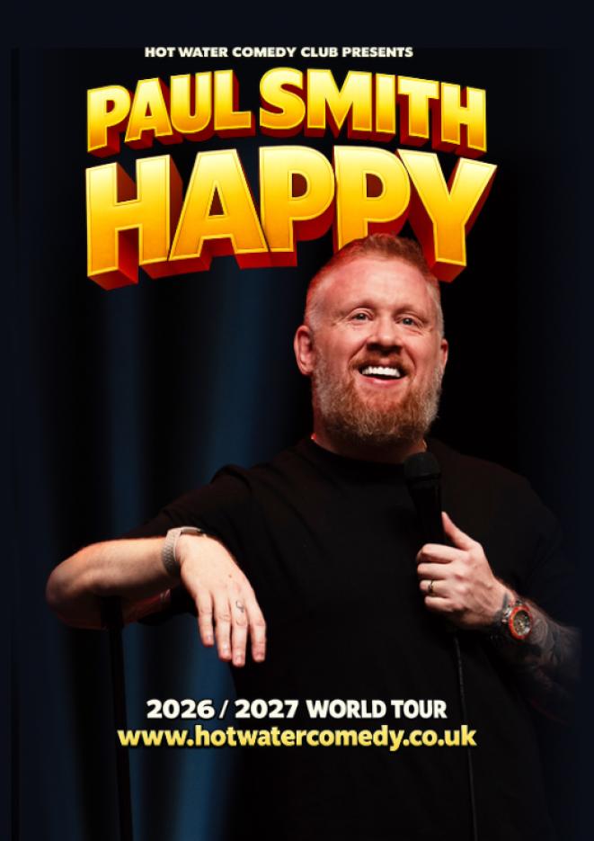 Comedian Paul Smith leans on a microphone stand against a plain black background, wearing a black top. Text above reads Paul Smith, Happy.