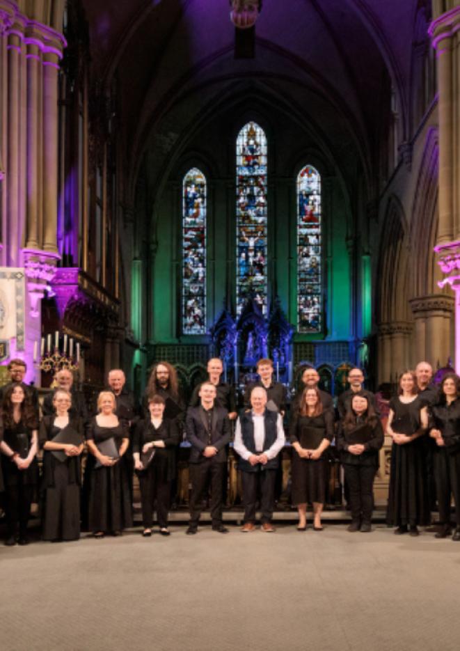A choir stand in a church setting with purple and green lights in the background.