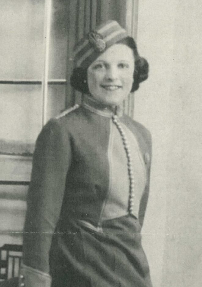 A black and white image of a young woman working as an usher.
